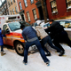 Residents try to help first responders move their vehicle.